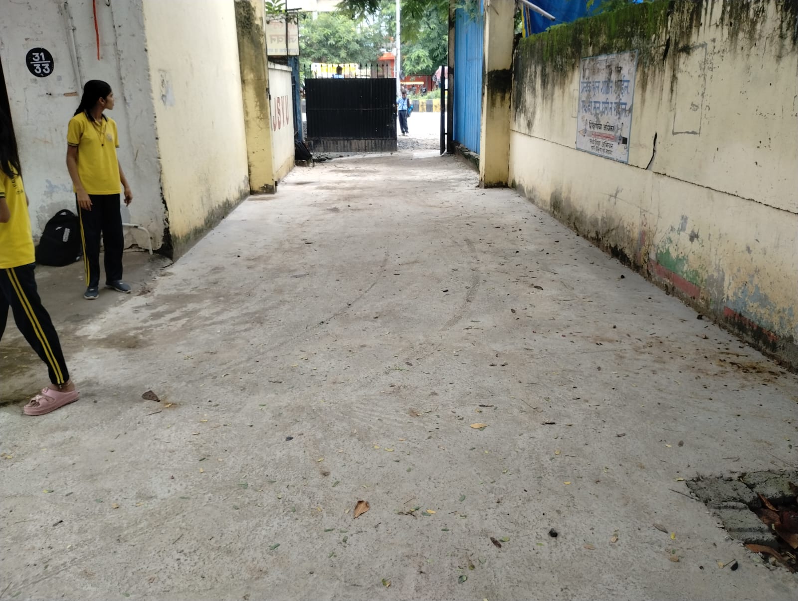 Improved concrete circulation path leading to the school entrance