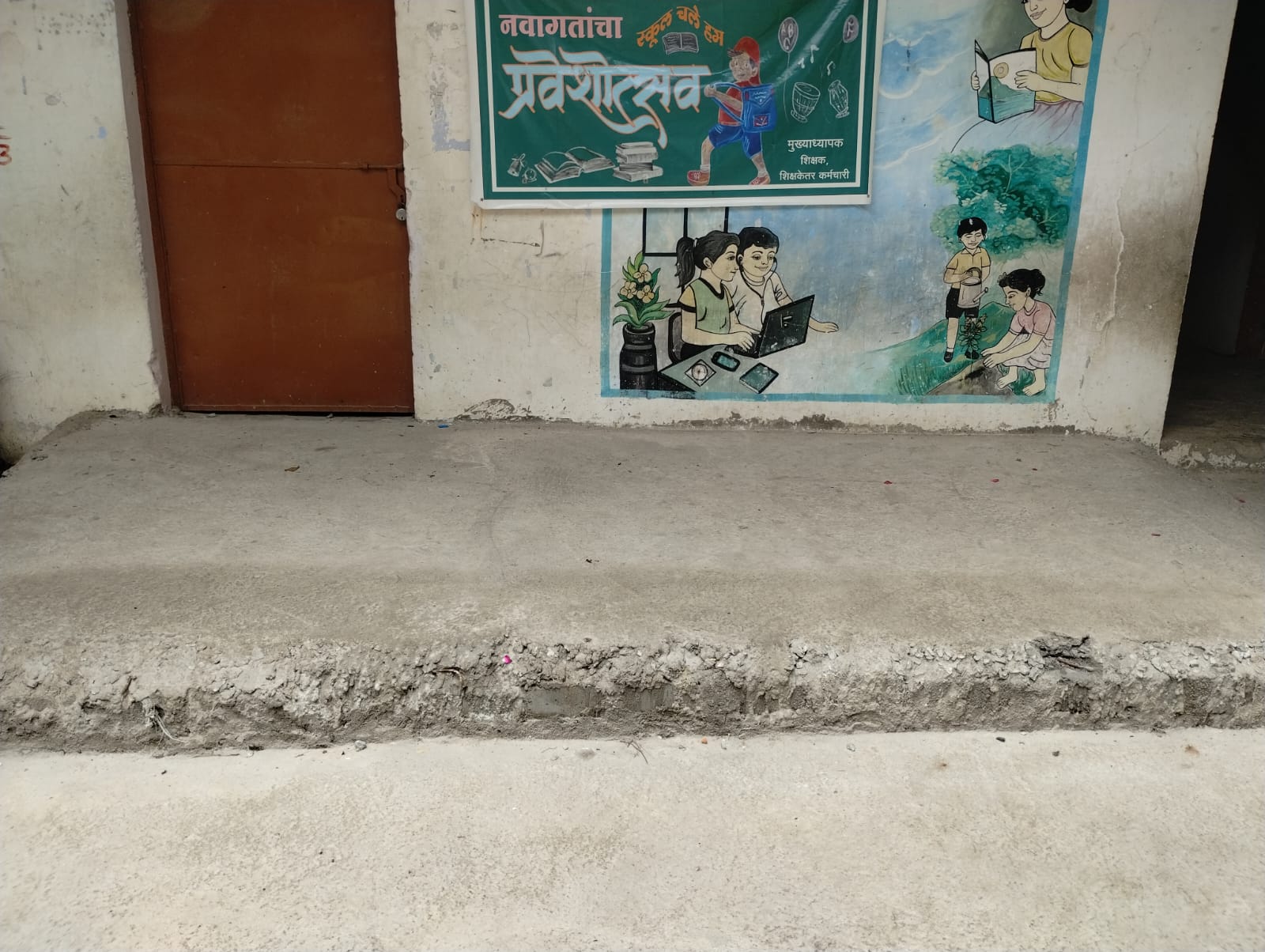 Finished concrete access area beside a learning wall at the school